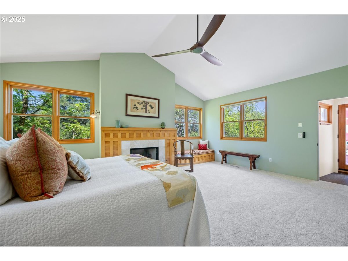 4908 Southwest Barnes Road Portland, OR 97221 - Photo 23 of 40 a bedroom with a bed and a large window
