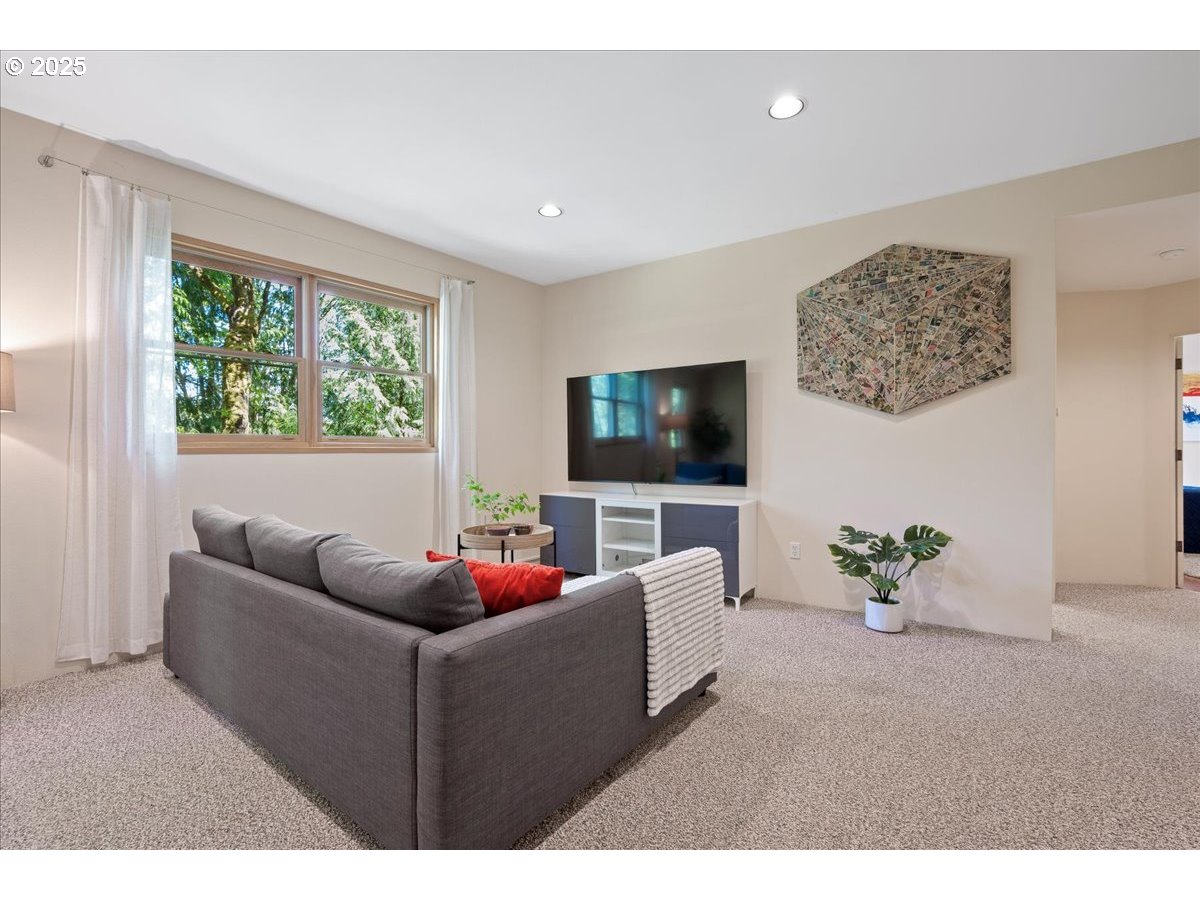 4908 Southwest Barnes Road Portland, OR 97221 - Photo 32 of 40 a living room with furniture and a flat screen tv