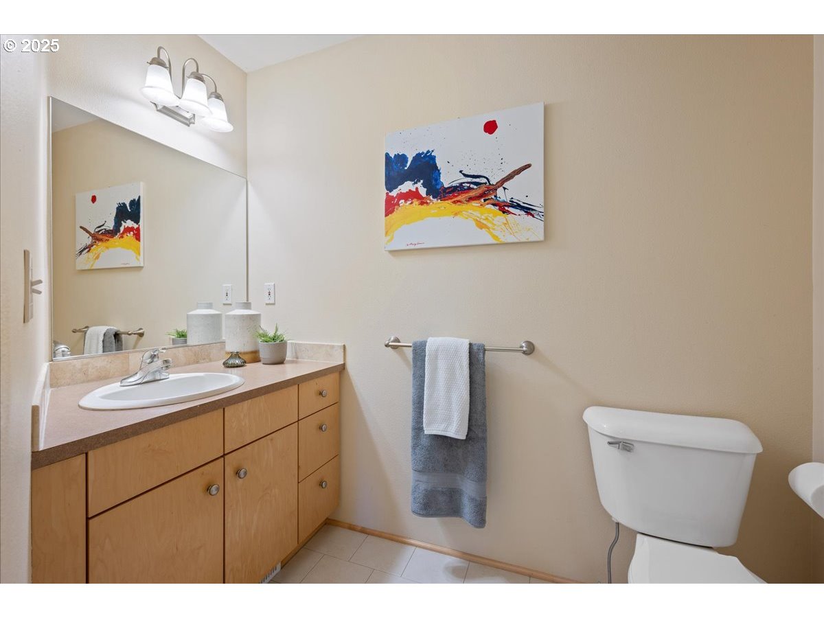 4908 Southwest Barnes Road Portland, OR 97221 - Photo 36 of 40 a bathroom with a toilet a sink and mirror