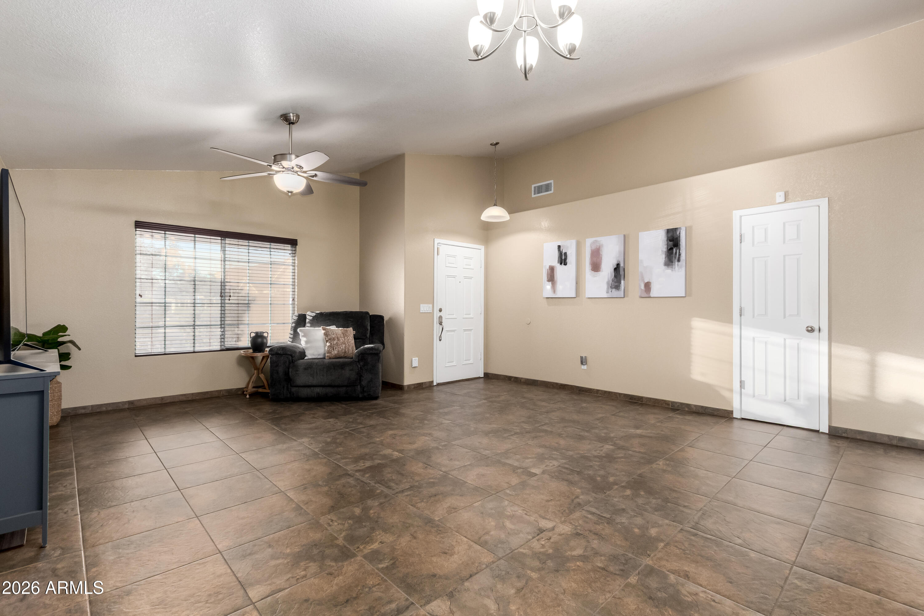 1147 North Marvin Street Gilbert, AZ 85233 - Photo 11 of 31 a living room with furniture and a chandelier