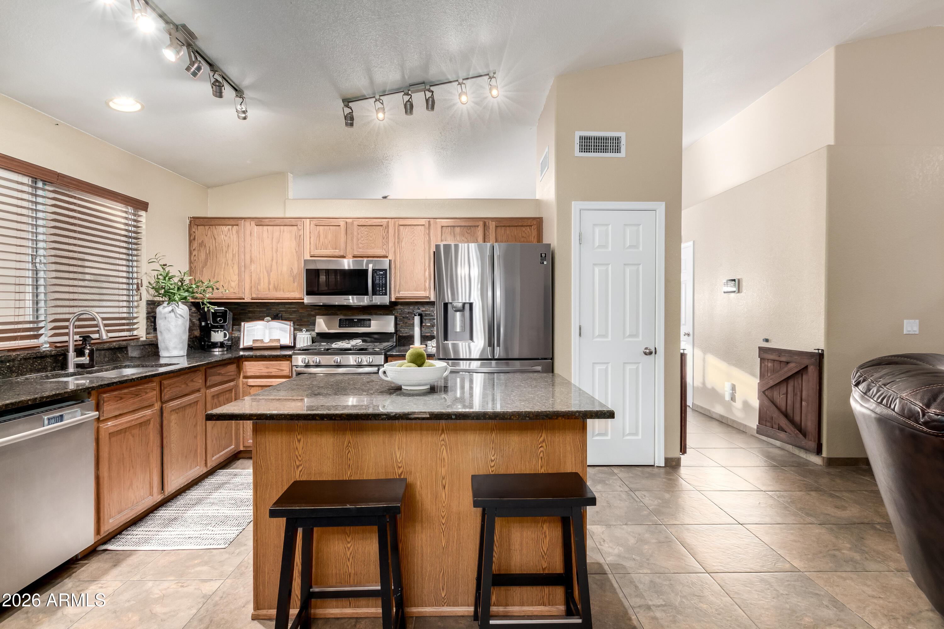 1147 North Marvin Street Gilbert, AZ 85233 - Photo 2 of 31 a large kitchen with granite countertop lots of counter space and window