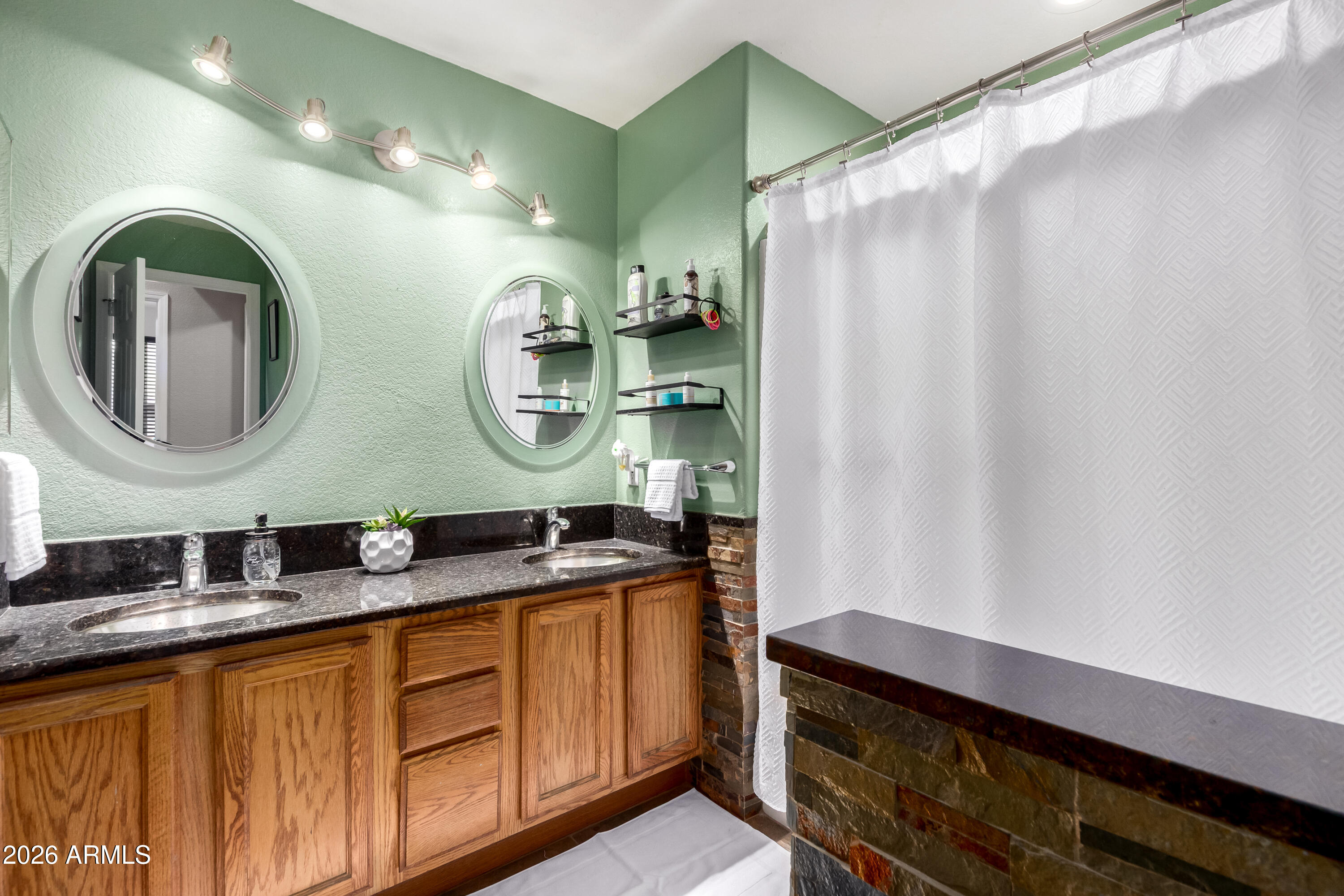 1147 North Marvin Street Gilbert, AZ 85233 - Photo 24 of 31 a bathroom with a double vanity sink and a mirror