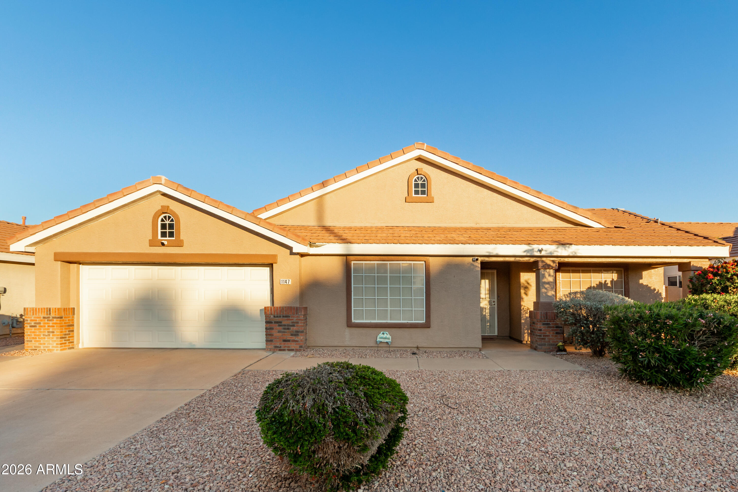 1147 North Marvin Street Gilbert, AZ 85233 - Photo 27 of 31 a front view of a house with garden