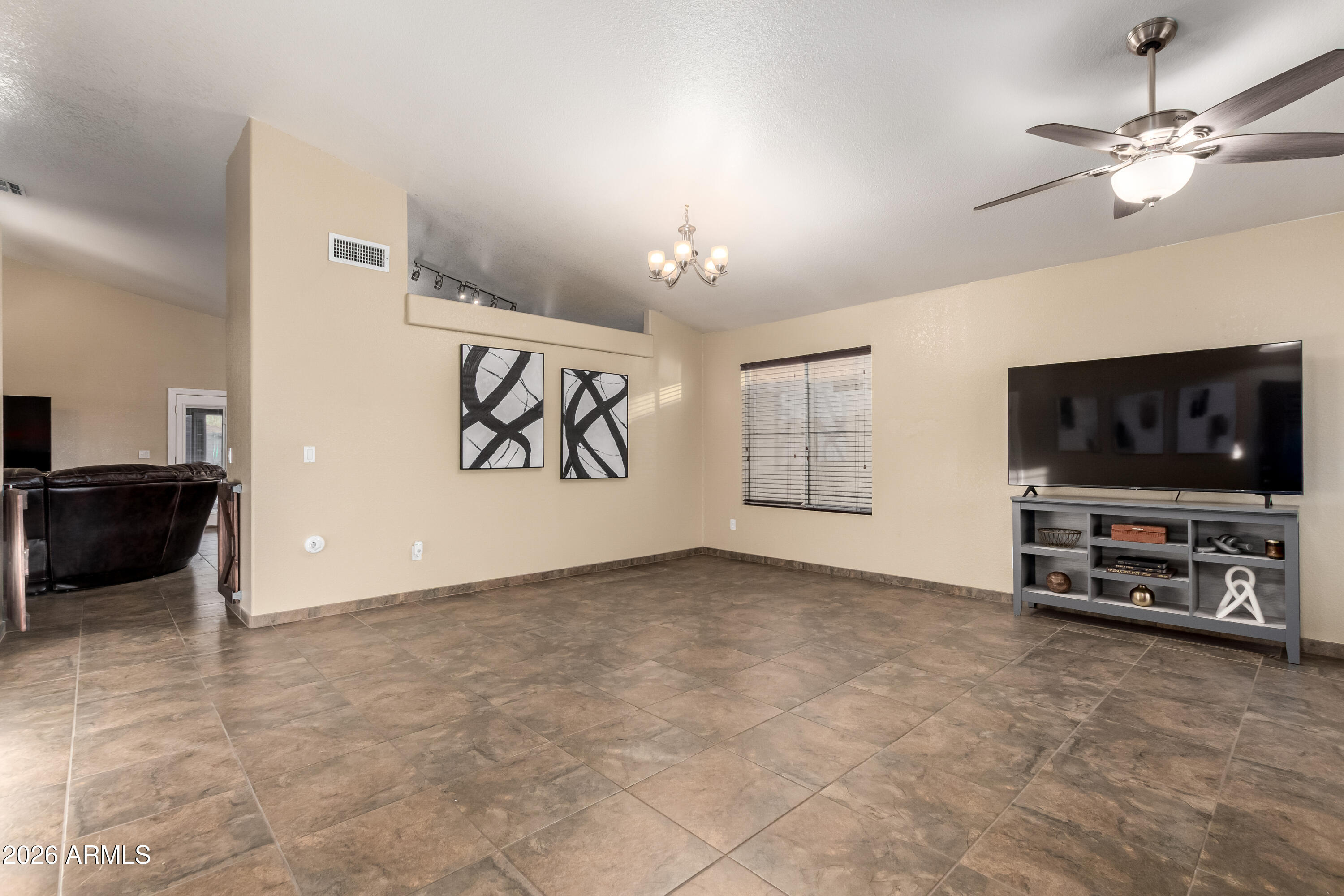 1147 North Marvin Street Gilbert, AZ 85233 - Photo 9 of 31 an living room with furniture and a flat screen tv