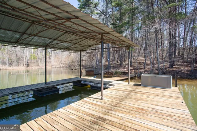 a swimming pool with outdoor seating and yard