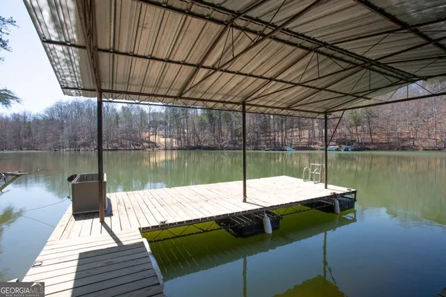 a view of a lake with couches chairs
