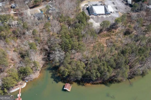 an aerial view of residential house with outdoor space and lake view
