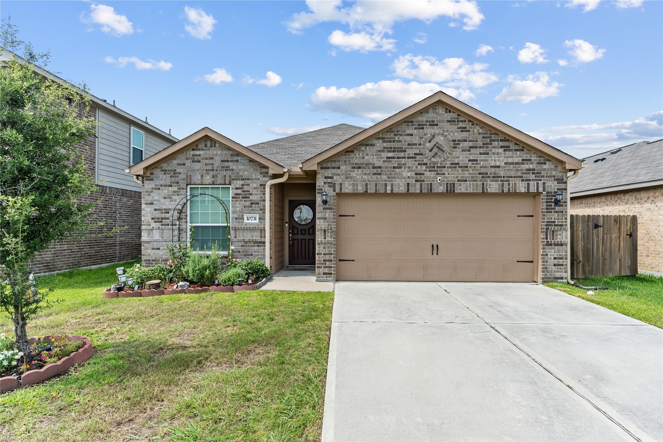 10731 Spring Brook Pass Drive Humble, TX 77396 - Photo 1 of 31 a front view of a house with a yard and garage