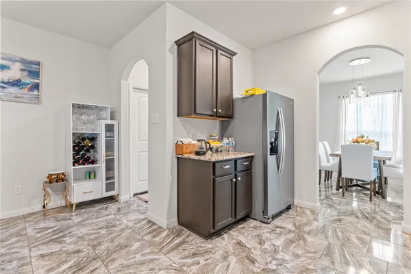 a kitchen with stainless steel appliances granite countertop a refrigerator and a sink