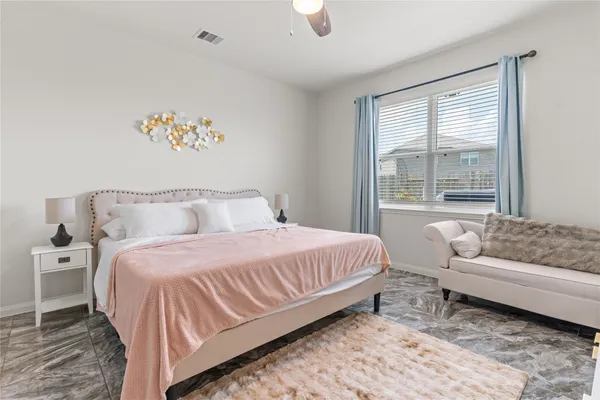 a bedroom with a large bed and a couch