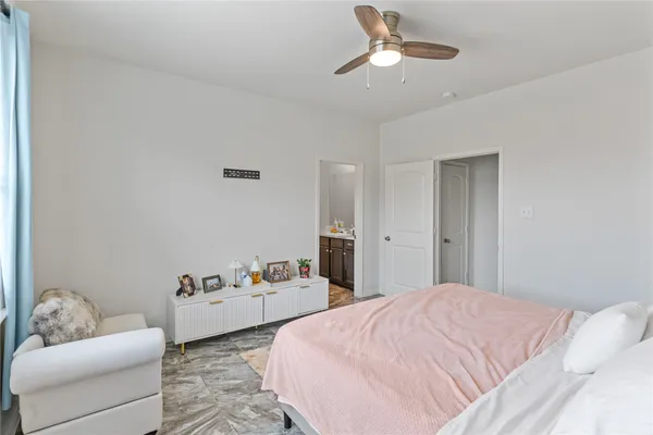 a spacious bedroom with a bed and couch