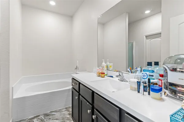 a bath room with a sink and a bath tub