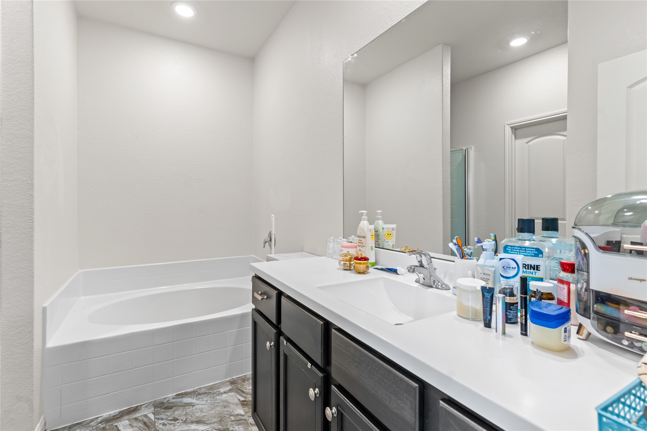 10731 Spring Brook Pass Drive Humble, TX 77396 - Photo 20 of 31 a bath room with a sink and a bath tub