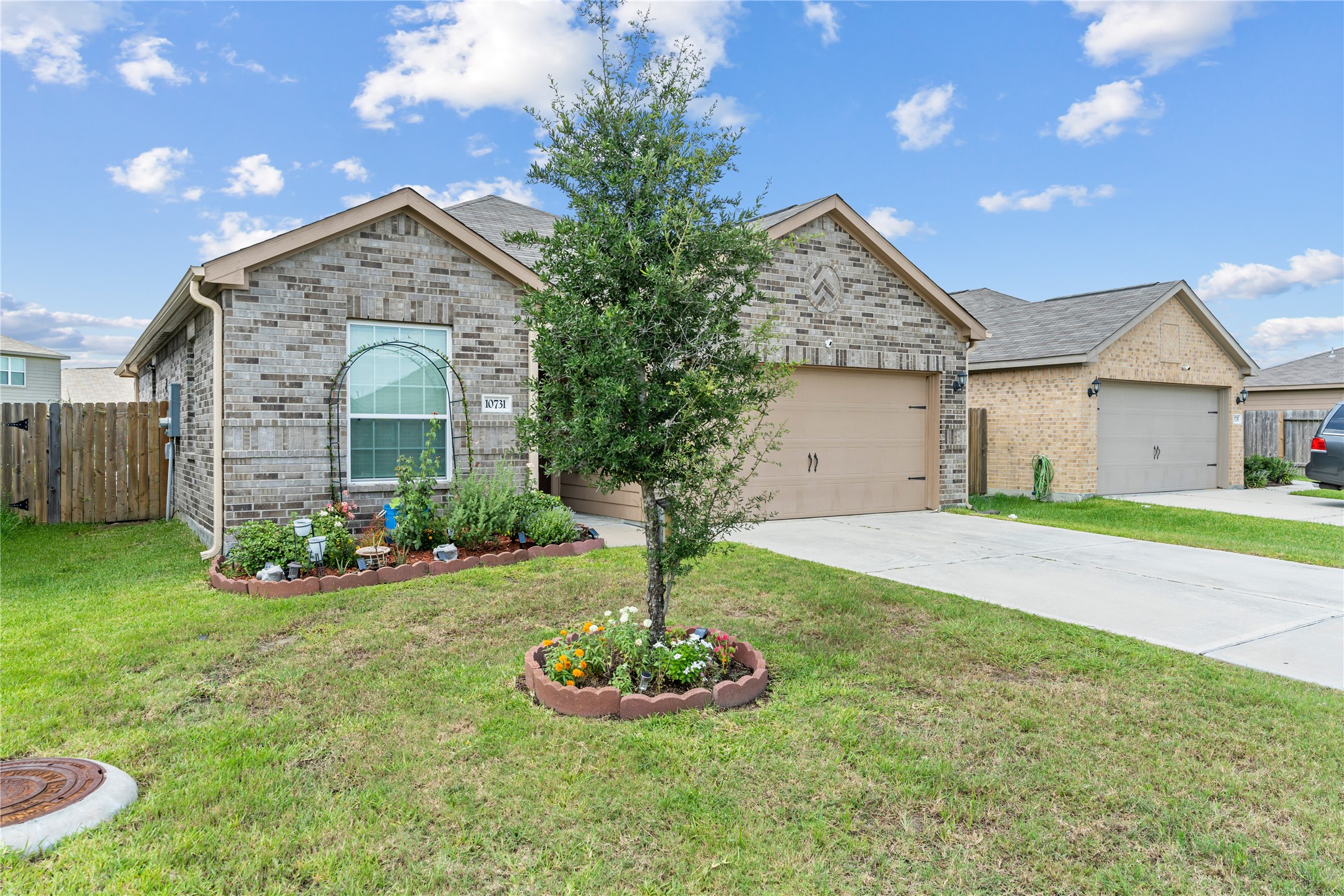 10731 Spring Brook Pass Drive Humble, TX 77396 - Photo 2 of 31 a front view of a house with a yard and garage