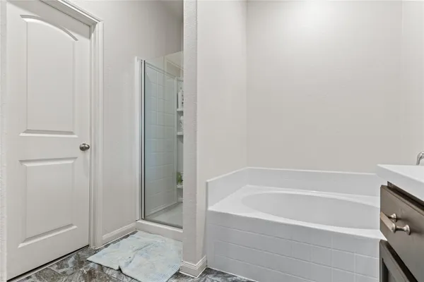 a bathroom with a bathtub and shower