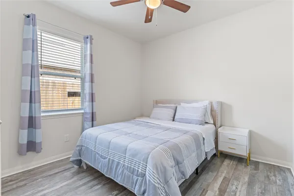 a bedroom with a bed and a window