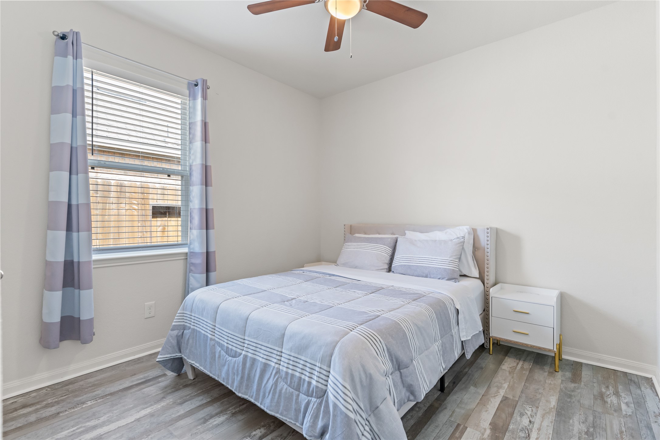 10731 Spring Brook Pass Drive Humble, TX 77396 - Photo 23 of 31 a bedroom with a bed and a window