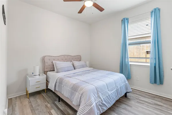 a bedroom with a bed and a large window