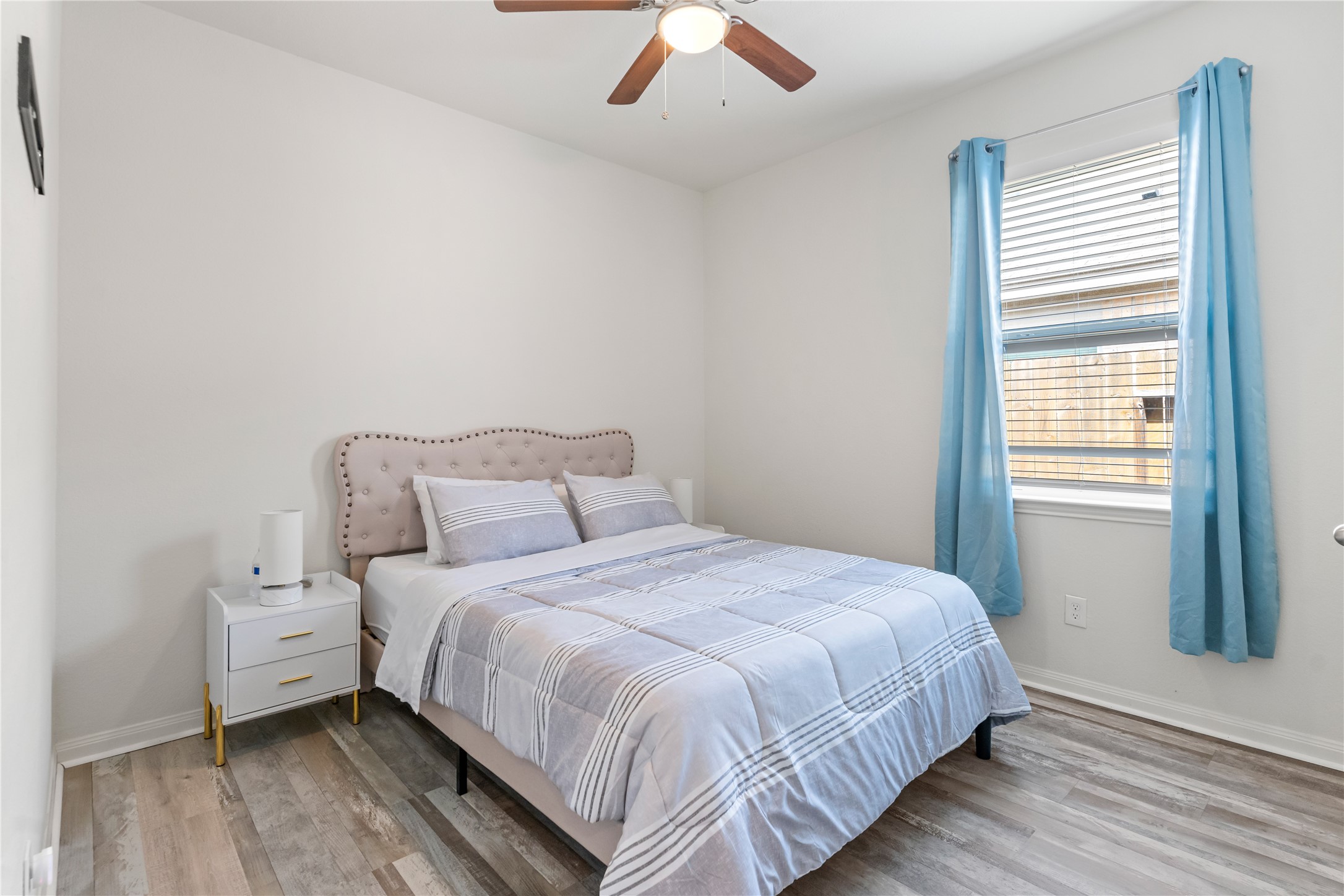 10731 Spring Brook Pass Drive Humble, TX 77396 - Photo 24 of 31 a bedroom with a bed and a large window