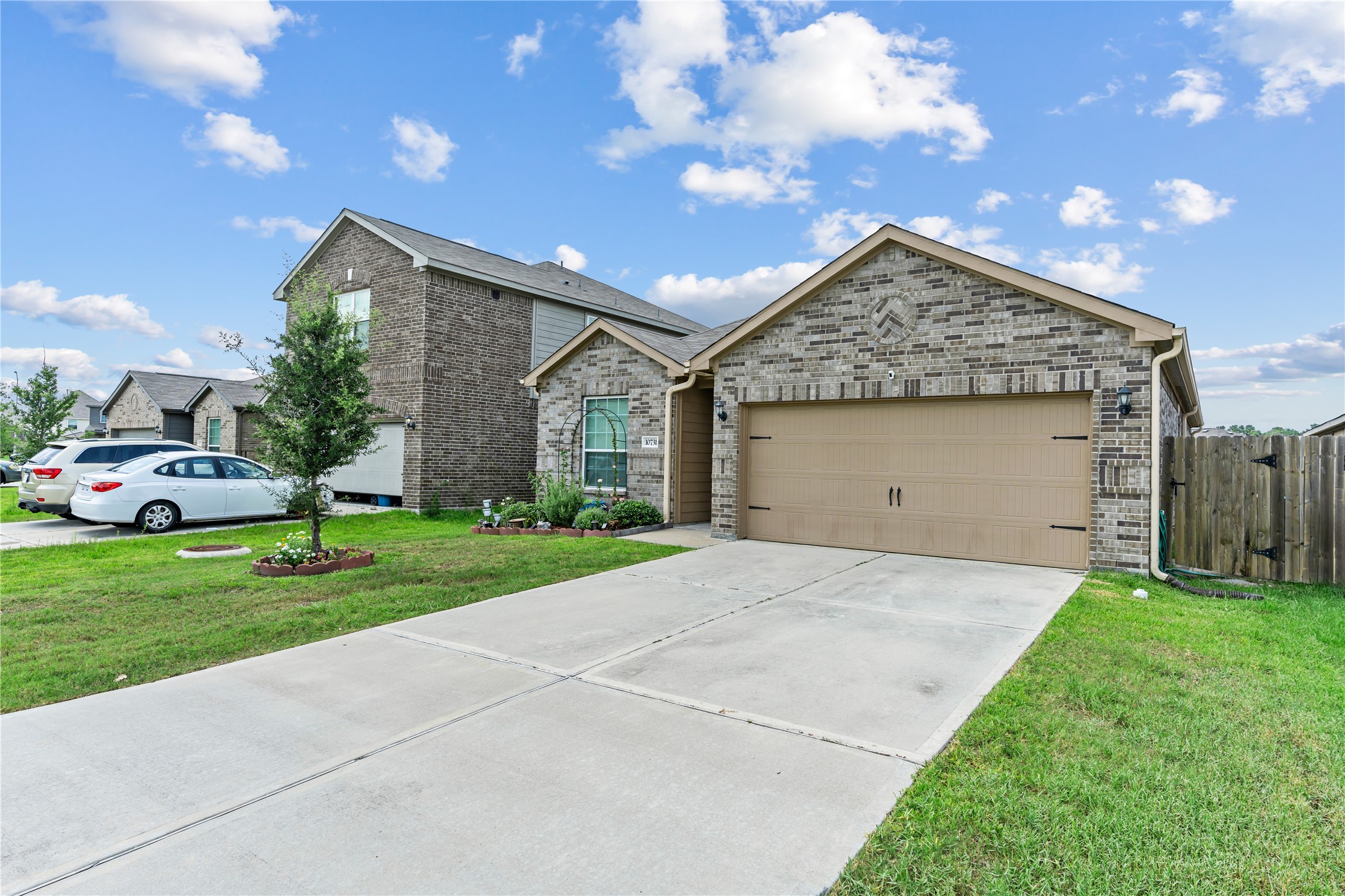 10731 Spring Brook Pass Drive Humble, TX 77396 - Photo 3 of 31 a front view of a house with a yard and garage