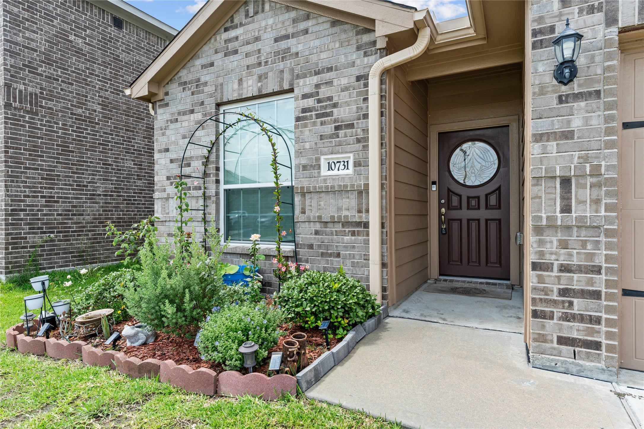10731 Spring Brook Pass Drive Humble, TX 77396 - Photo 4 of 31 a view of a door of a house with a small garden