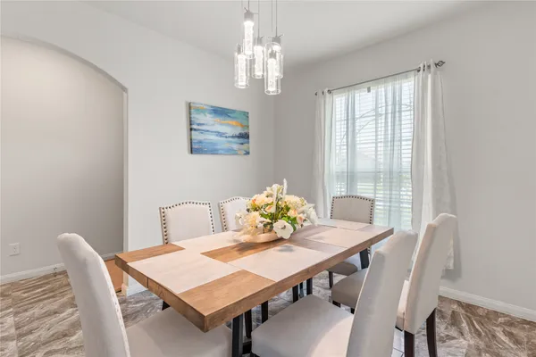 a view of a dining room with furniture and window