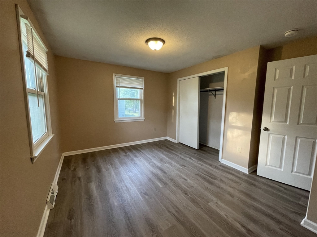 15 Carriage Lane Amherst, MA 01002 - Photo 13 of 23 a view of an empty room with wooden floor and a window
