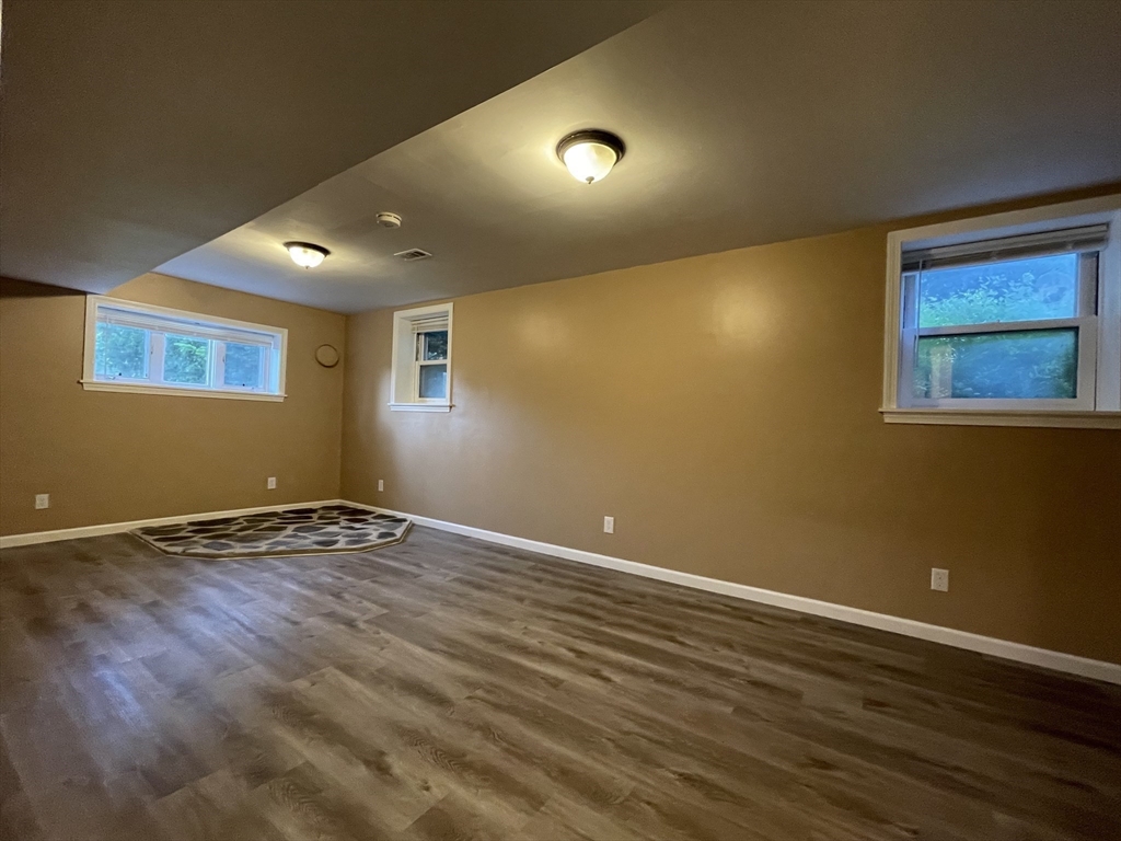 15 Carriage Lane Amherst, MA 01002 - Photo 18 of 23 a view of an empty room with wooden floor and a window