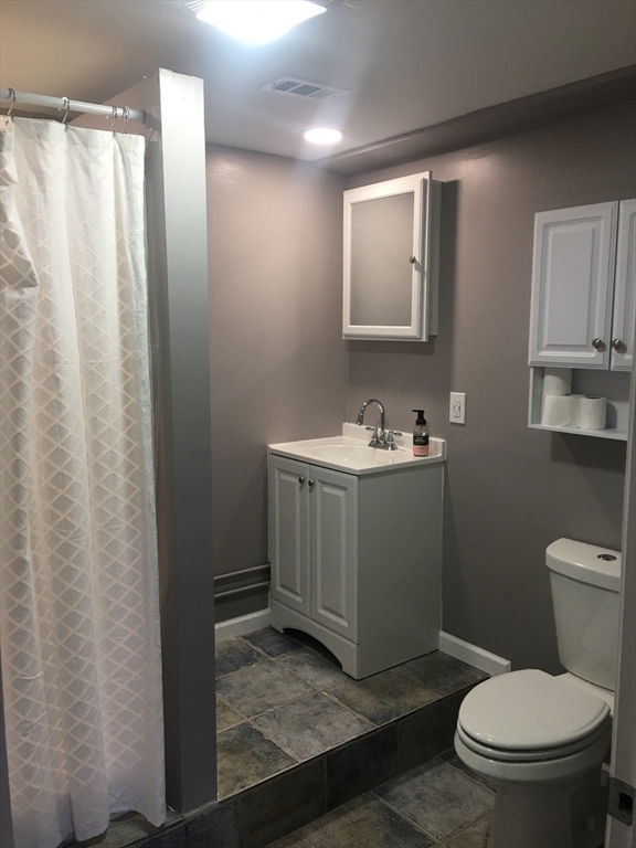 15 Carriage Lane Amherst, MA 01002 - Photo 19 of 23 a bathroom with a sink a toilet and mirror