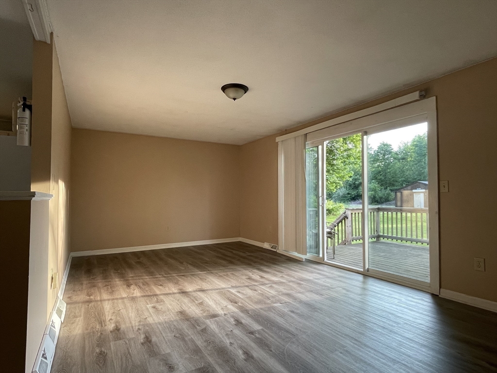 15 Carriage Lane Amherst, MA 01002 - Photo 6 of 23 wooden floor in an empty room with a window
