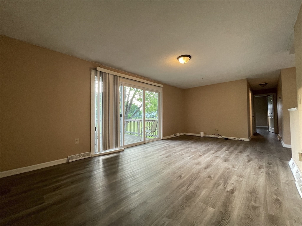 15 Carriage Lane Amherst, MA 01002 - Photo 7 of 23 a view of a room with wooden floor and a window