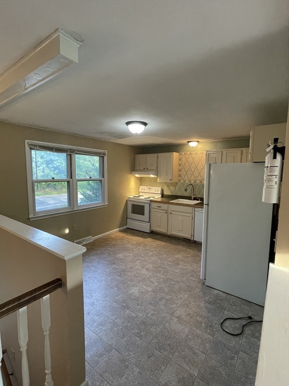 15 Carriage Lane Amherst, MA 01002 - Photo 9 of 23 a view of kitchen with refrigerator and window