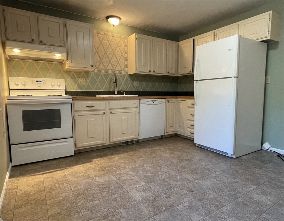 15 Carriage Lane Amherst, MA 01002 - Photo 10 of 23 a kitchen with cabinets appliances and a counter space
