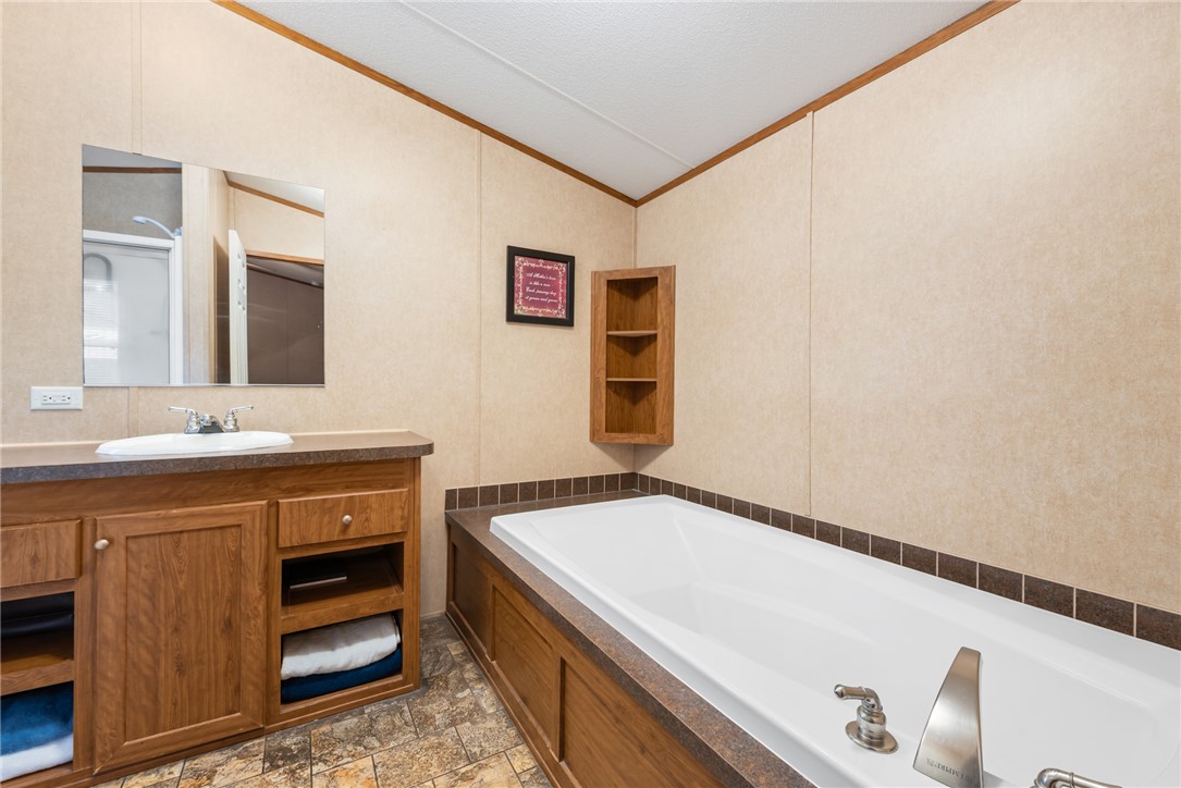 1061 Tafelski Road New Waverly, TX 77358 - Photo 17 of 37 a bathroom with a sink and a mirror