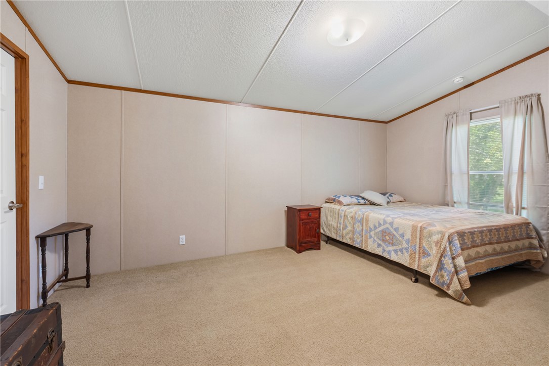 1061 Tafelski Road New Waverly, TX 77358 - Photo 19 of 37 a bedroom with a bed and a window