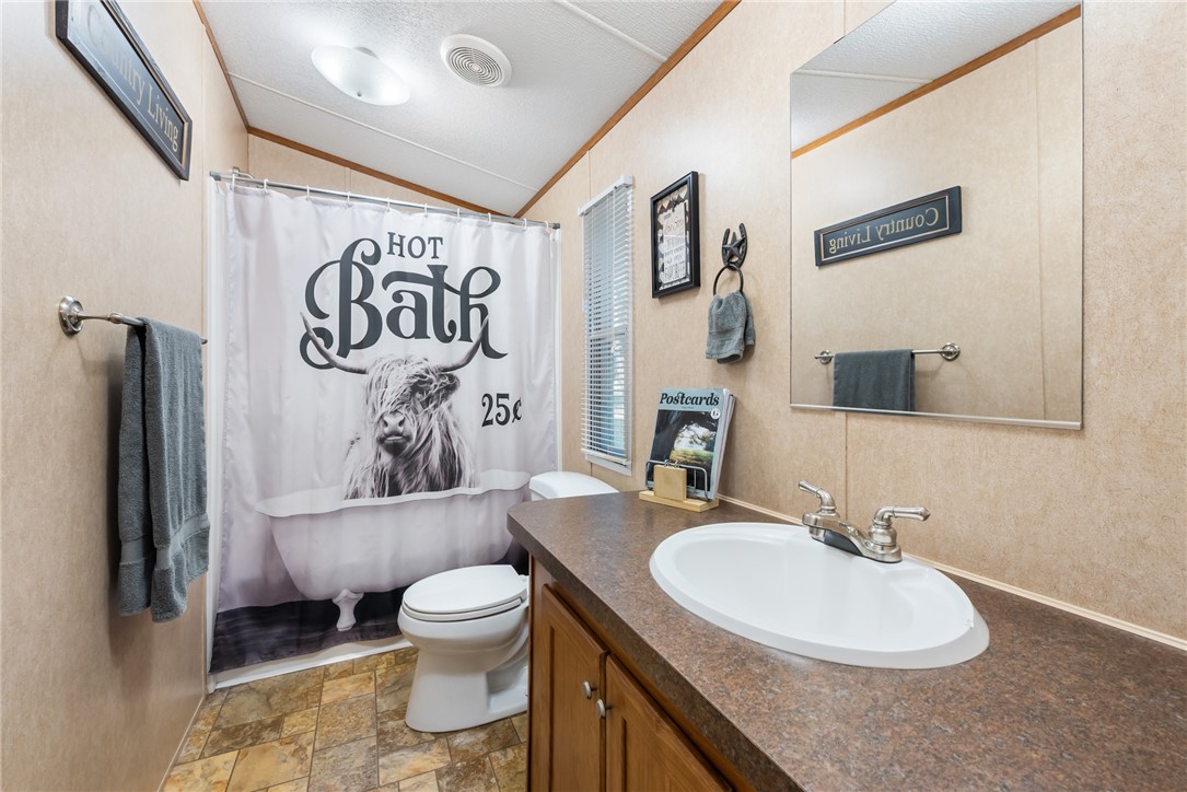1061 Tafelski Road New Waverly, TX 77358 - Photo 20 of 37 a bathroom with a sink toilet and shower