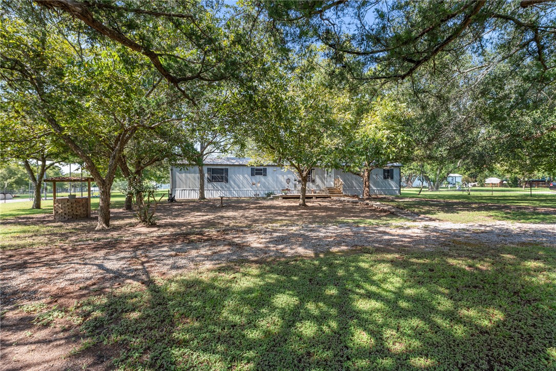 1061 Tafelski Road New Waverly, TX 77358 - Photo 2 of 37 a view of a house with backyard and trees