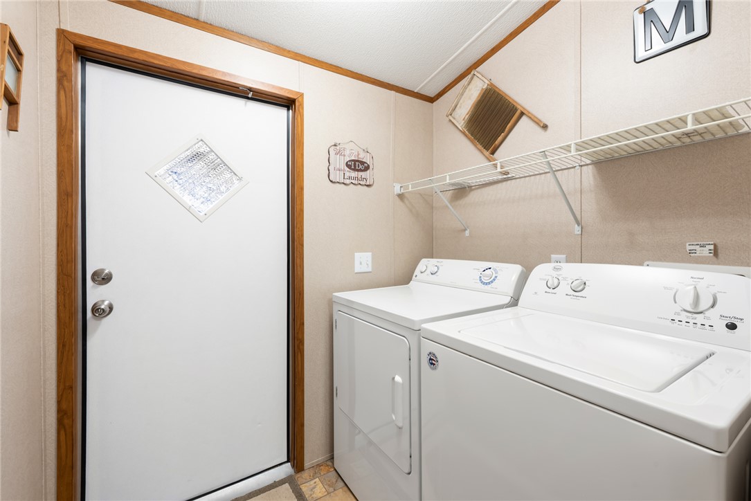 1061 Tafelski Road New Waverly, TX 77358 - Photo 21 of 37 a utility room with dryer and washer