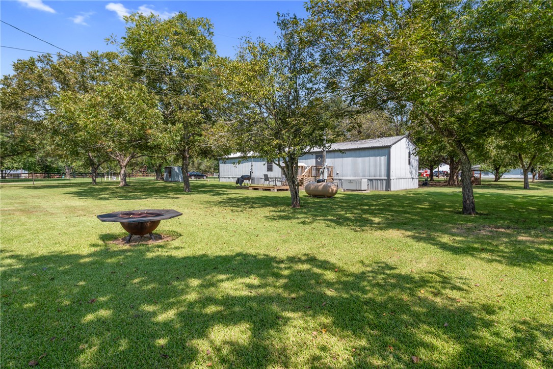 1061 Tafelski Road New Waverly, TX 77358 - Photo 25 of 37 a swimming pool with outdoor seating and yard