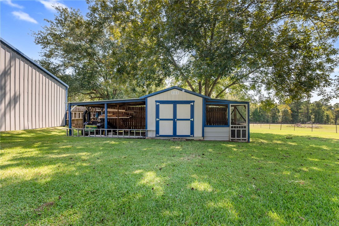 1061 Tafelski Road New Waverly, TX 77358 - Photo 27 of 37 a front view of house with yard and seating area