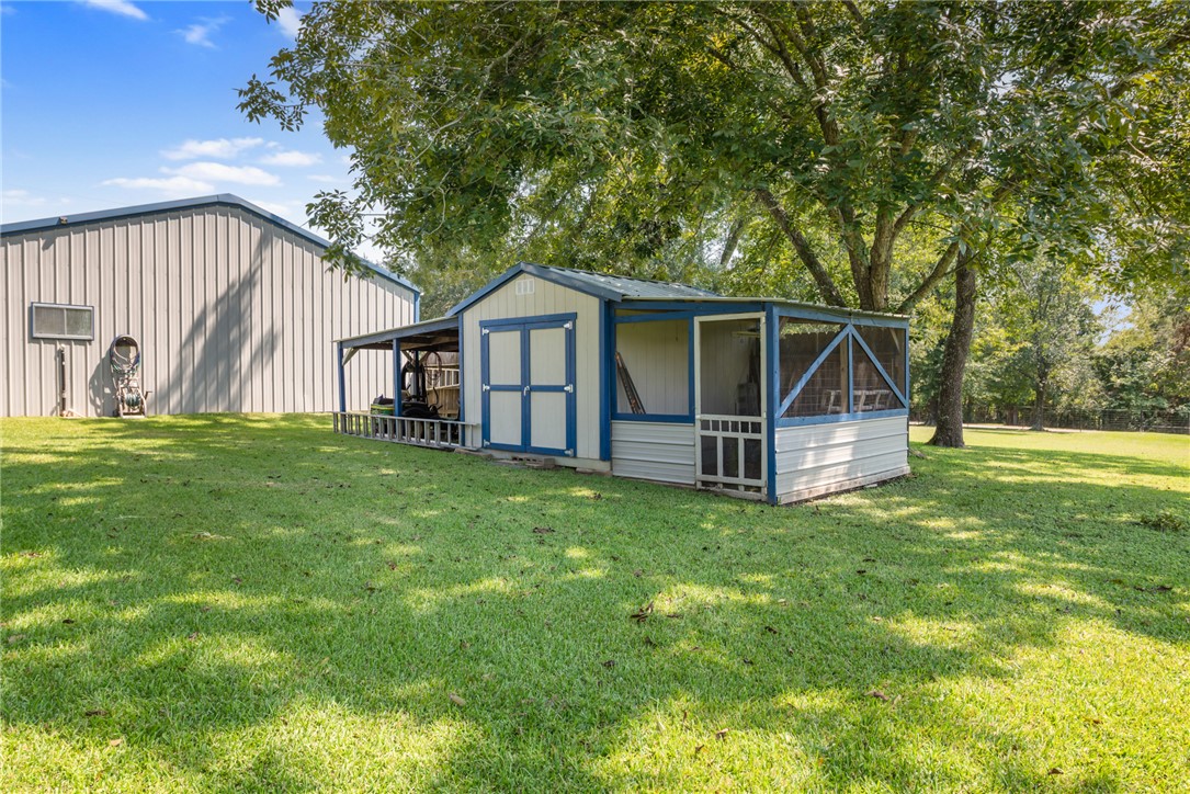 1061 Tafelski Road New Waverly, TX 77358 - Photo 28 of 37 a view of a house with a big yard and large trees