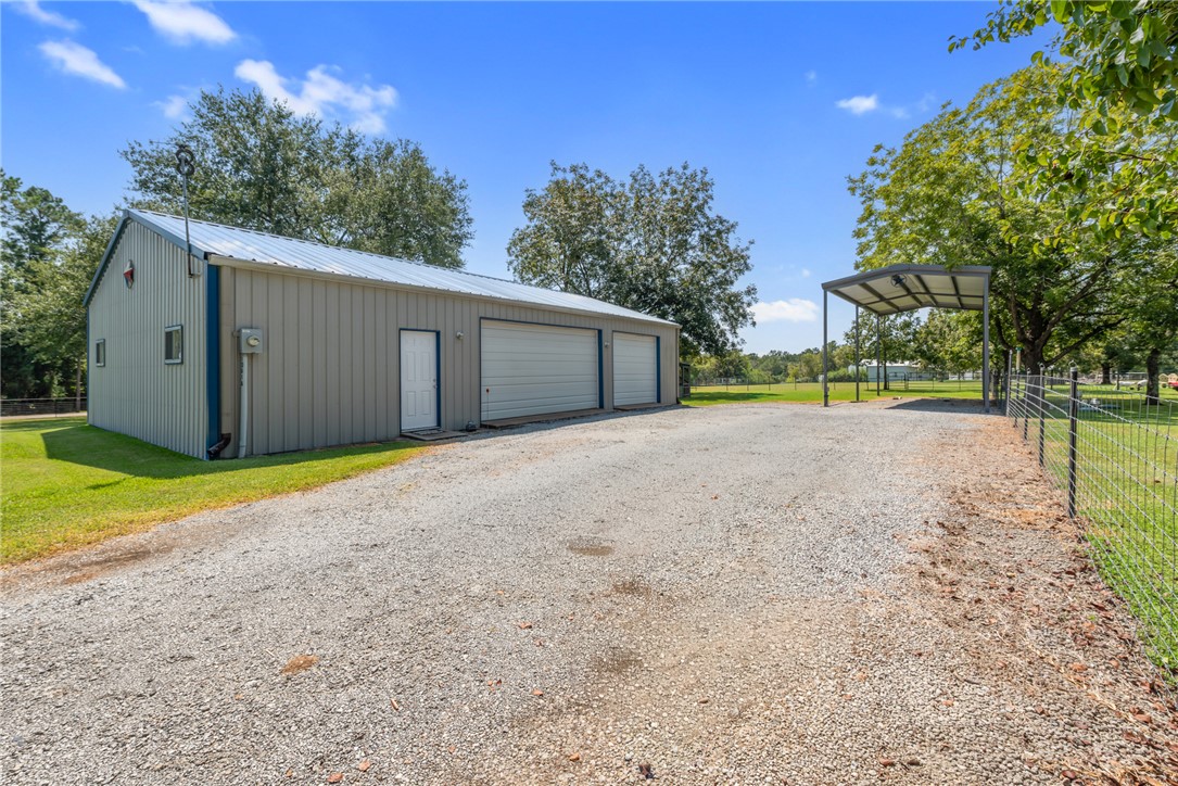 1061 Tafelski Road New Waverly, TX 77358 - Photo 29 of 37 a view of a house with backyard and trees