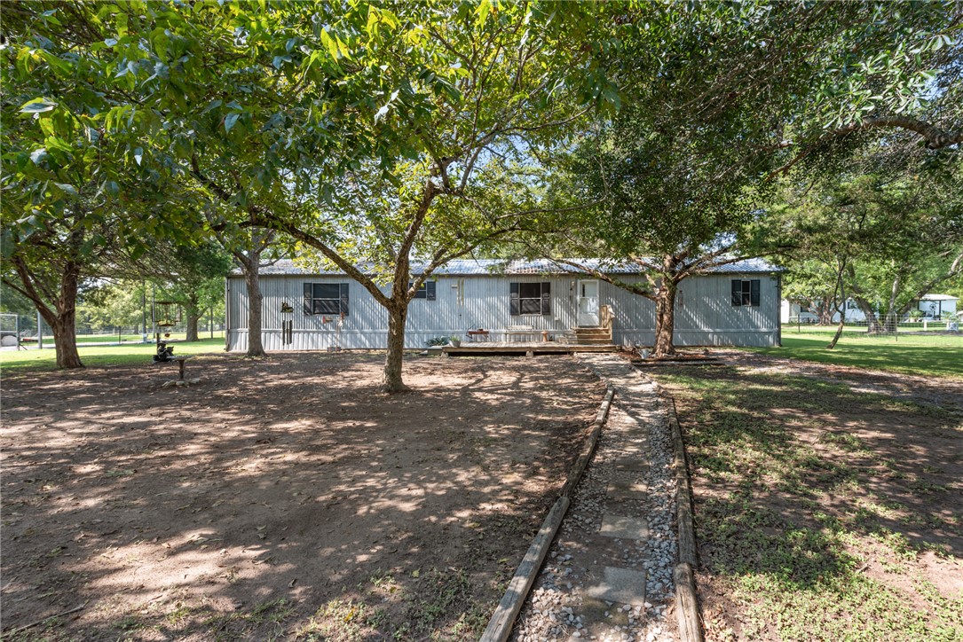 1061 Tafelski Road New Waverly, TX 77358 - Photo 6 of 37 a front view of a house with a yard