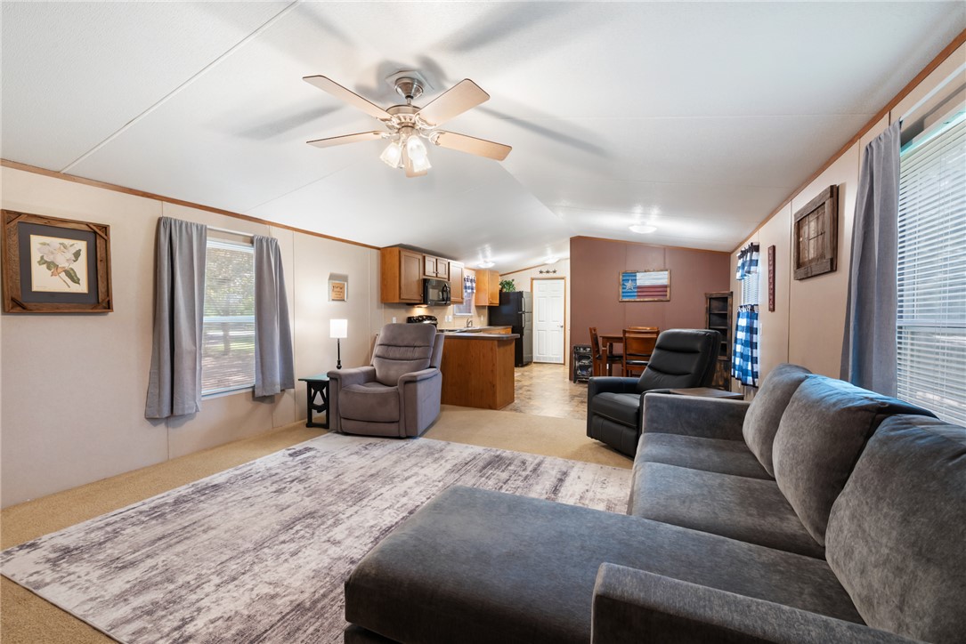 1061 Tafelski Road New Waverly, TX 77358 - Photo 9 of 37 a living room with furniture and a chandelier