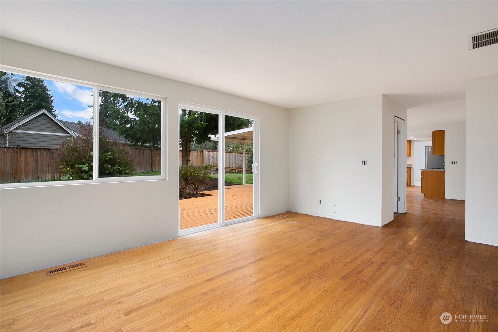 16810 143rd Avenue Southeast Renton, WA 98058 - Photo 12 of 38 a view of an empty room with a window and hardwood floor