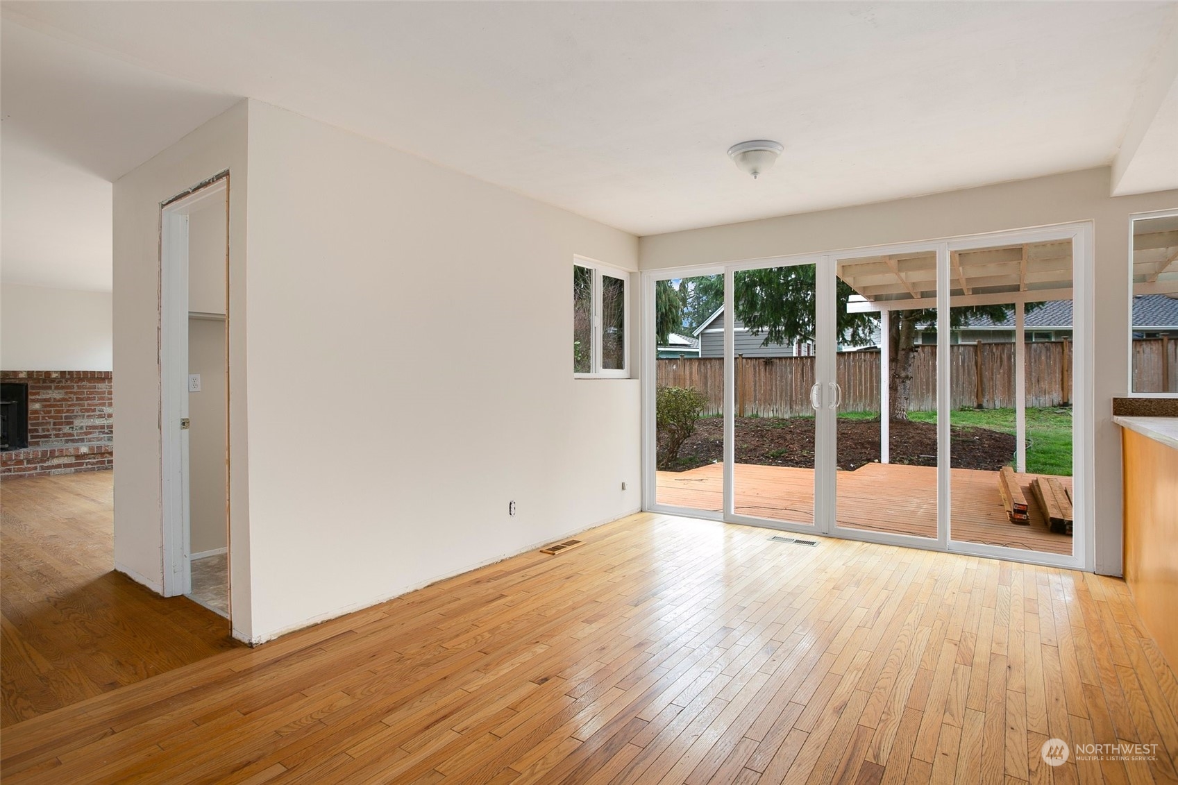16810 143rd Avenue Southeast Renton, WA 98058 - Photo 13 of 38 a view of an empty room with wooden floor and a window