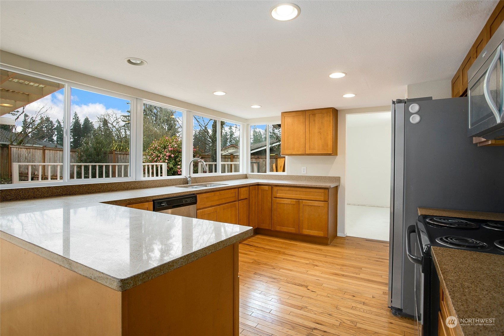 16810 143rd Avenue Southeast Renton, WA 98058 - Photo 14 of 38 a kitchen with stainless steel appliances granite countertop a sink and a refrigerator