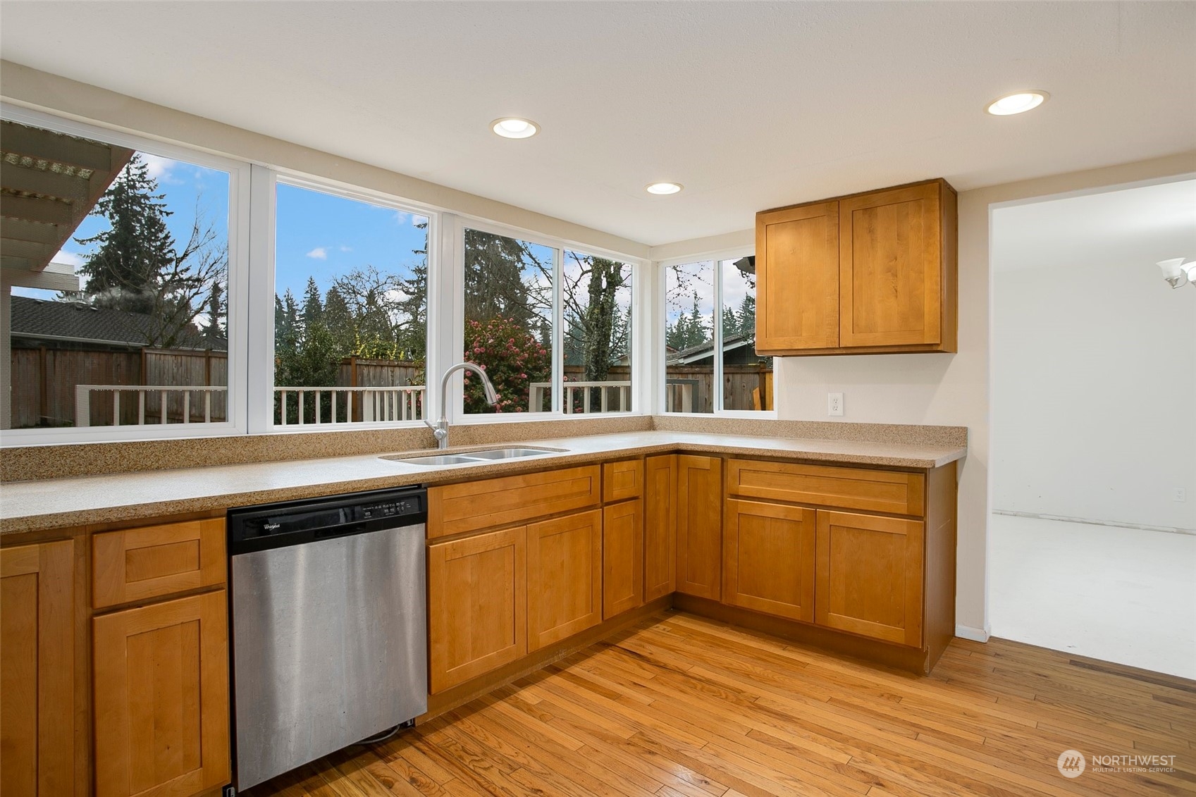 16810 143rd Avenue Southeast Renton, WA 98058 - Photo 17 of 38 a kitchen with stainless steel appliances granite countertop wooden cabinets a sink and a large window