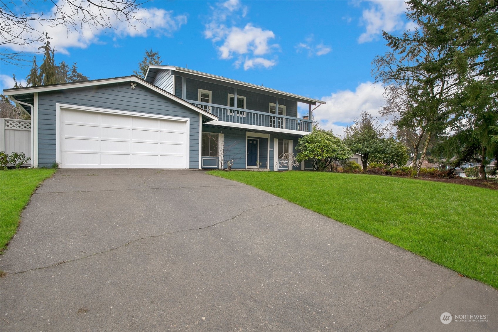 16810 143rd Avenue Southeast Renton, WA 98058 - Photo 3 of 38 a front view of a house with a yard and garage