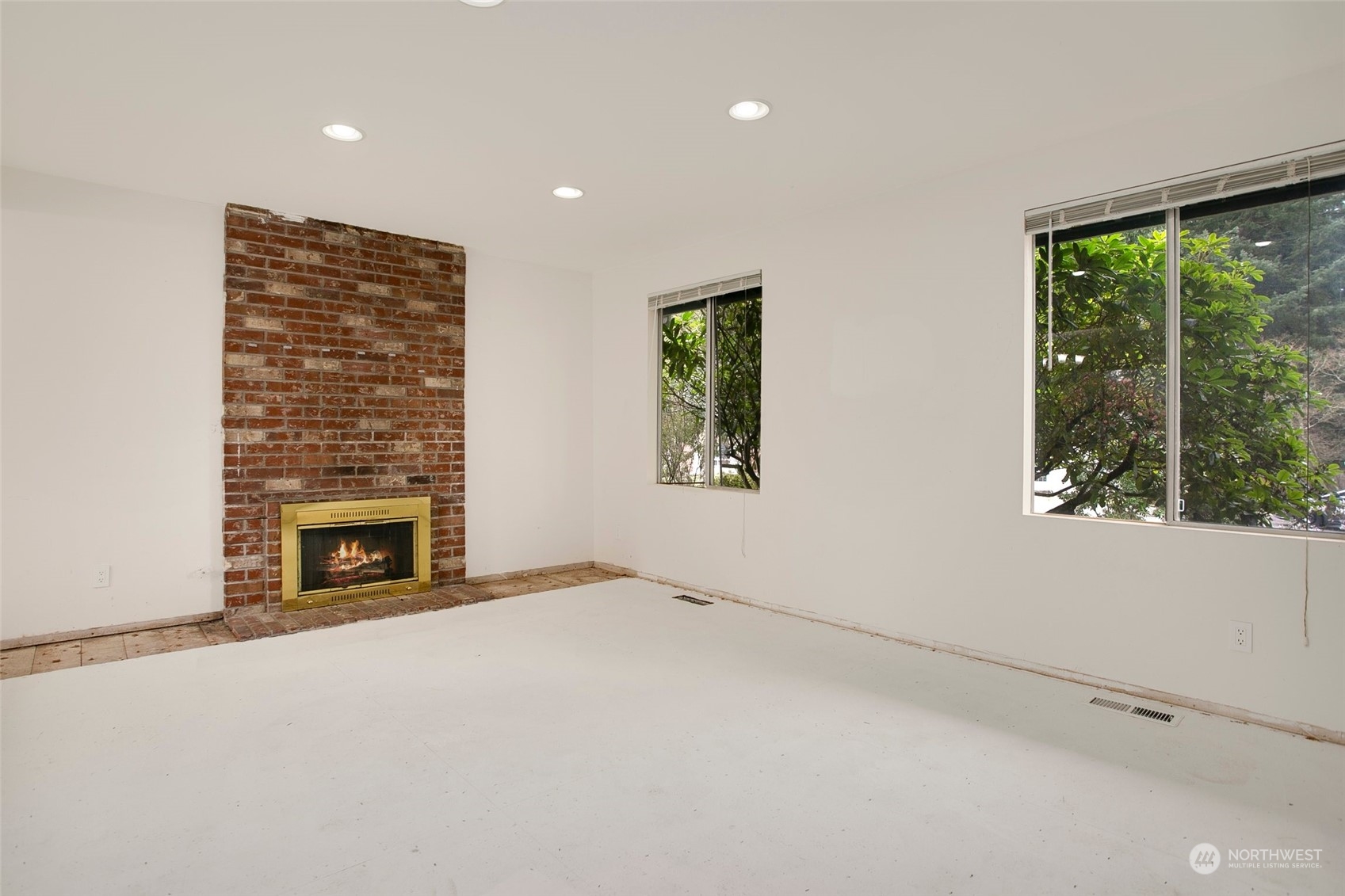 16810 143rd Avenue Southeast Renton, WA 98058 - Photo 4 of 38 a view of an empty room with a fireplace and a window